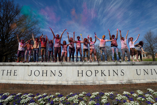 Students celebrating Holi on the JHU wall at the Beach-Will Kirk 19